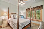 Take in the forested view from bed